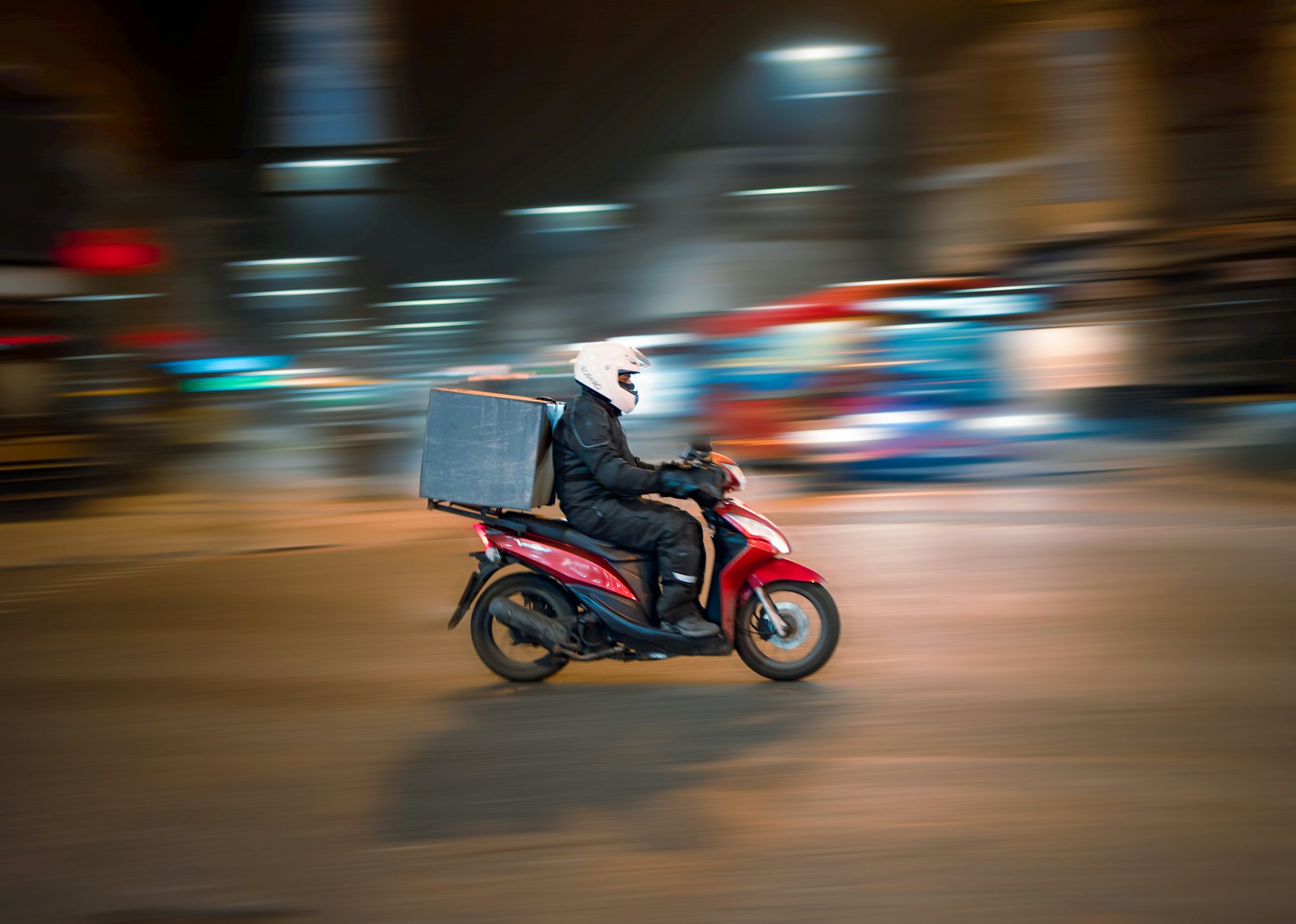 Express courier moving through the city at night